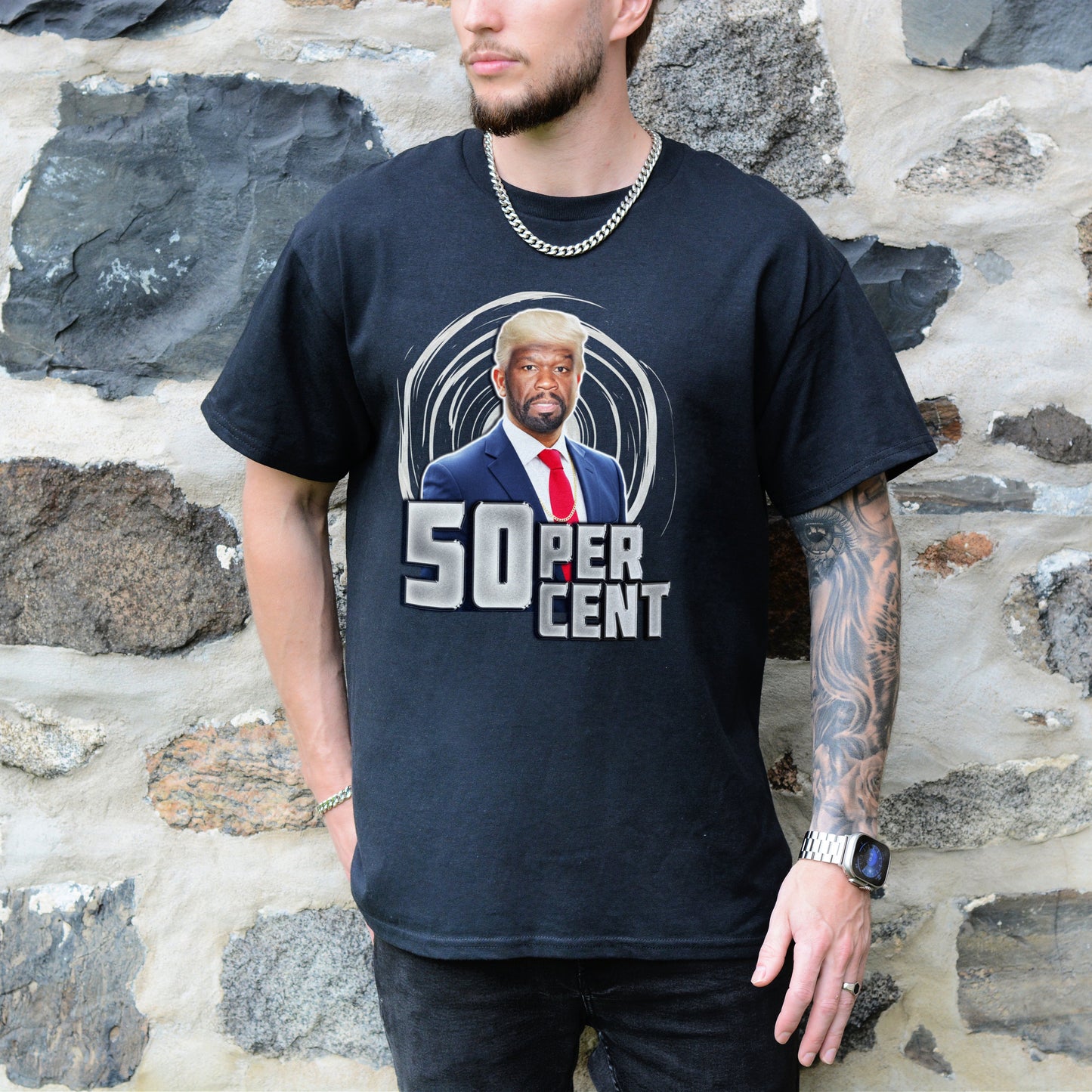 Person wearing a black t-shirt with '50 Cent' graphic design against a stone wall background