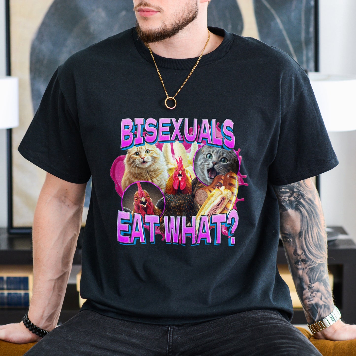 Person wearing a black t-shirt with colorful graphic design and text.