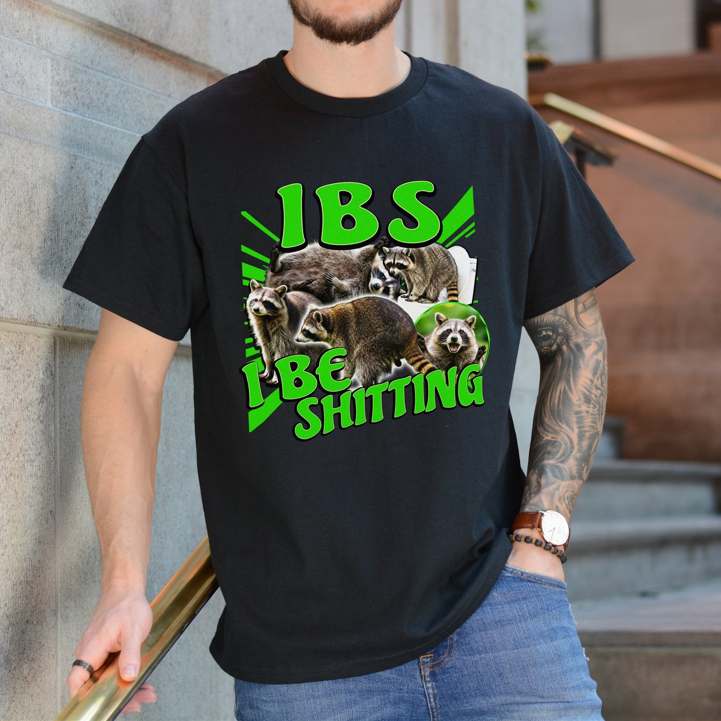 Person wearing a black t-shirt with graphic design and text, standing against a building.