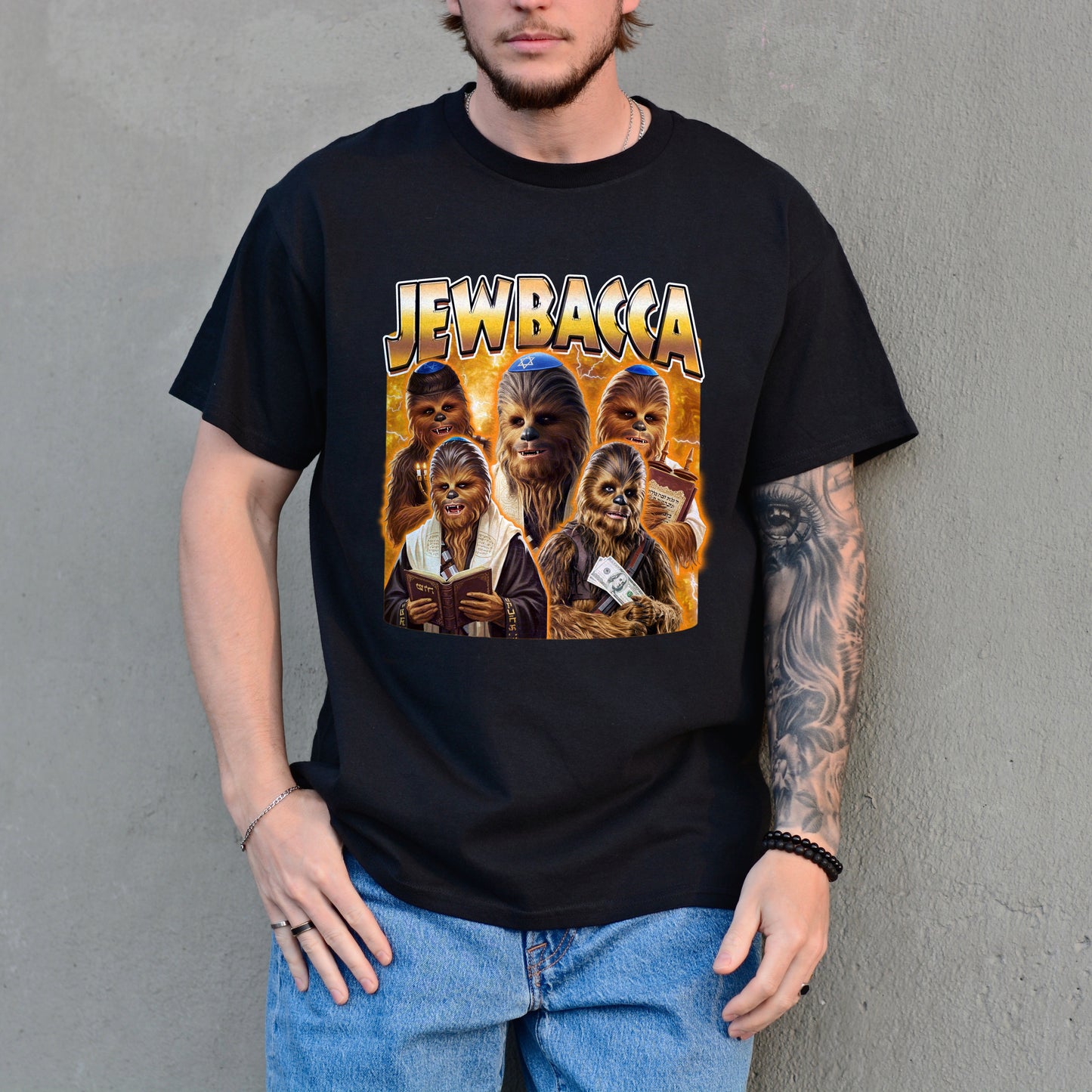 Person wearing a black t-shirt with 'Jewbacca' graphic design against a gray wall.
