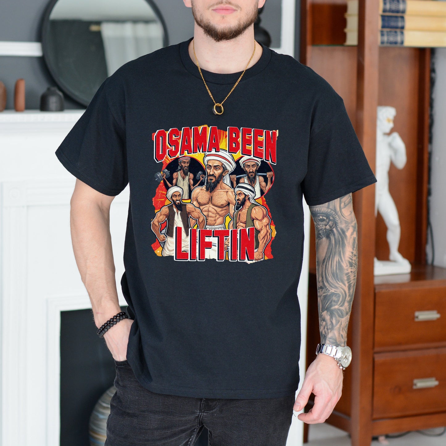Person wearing a black t-shirt with graphic design and text in a room.
