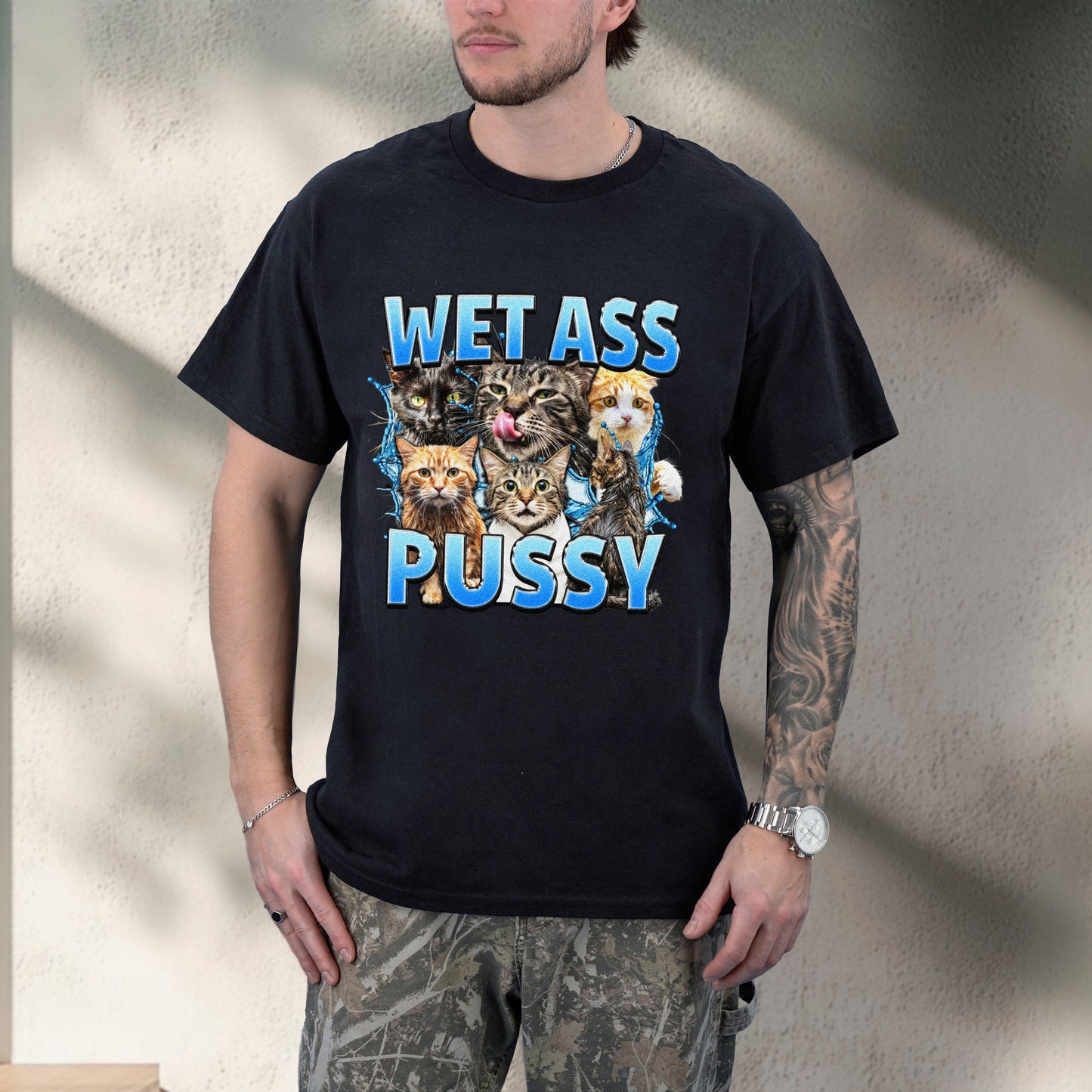 Person wearing a black t-shirt with graphic designs and text.