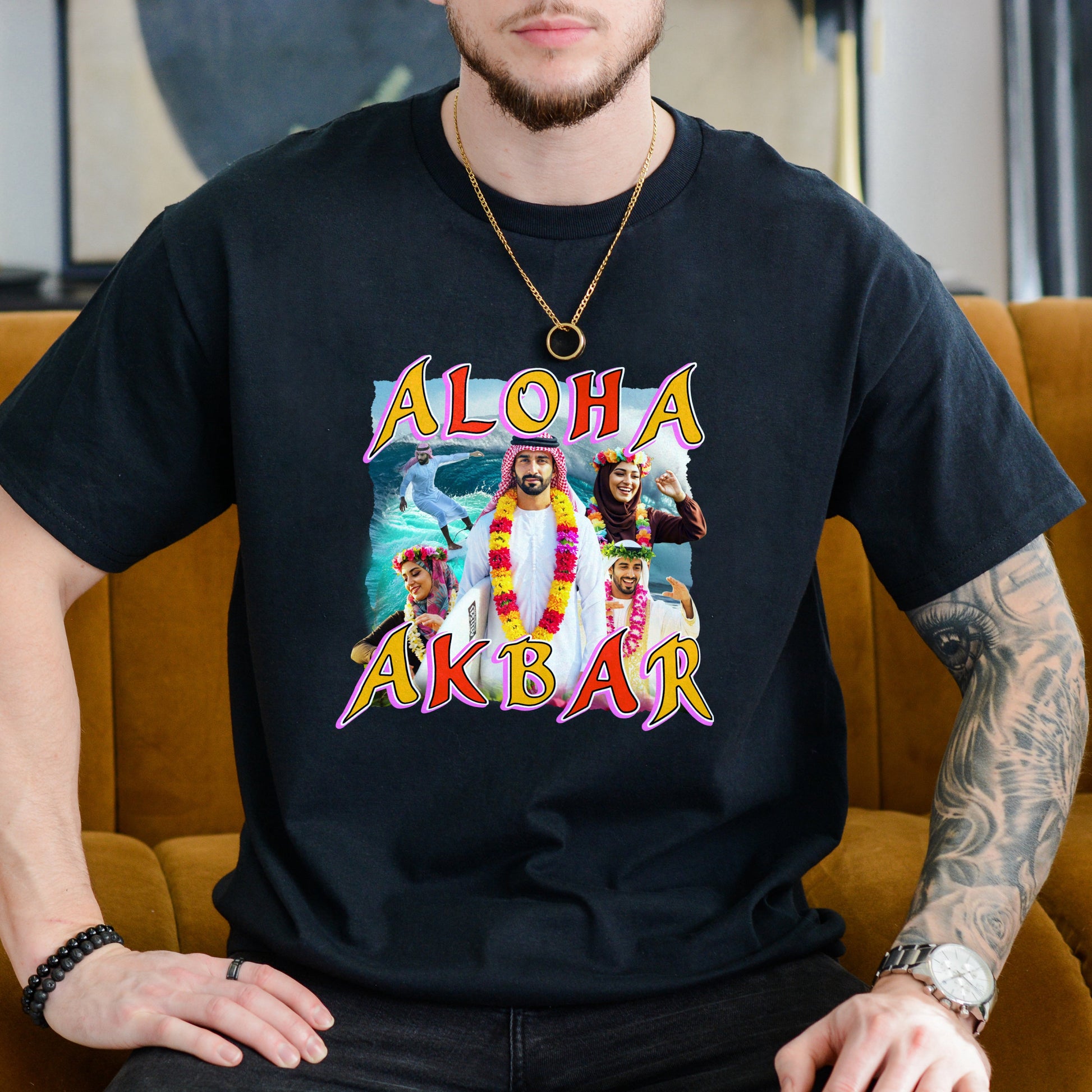 Person wearing a black t-shirt with 'Aloha Akbar' graphic design sitting on a mustard yellow couch.