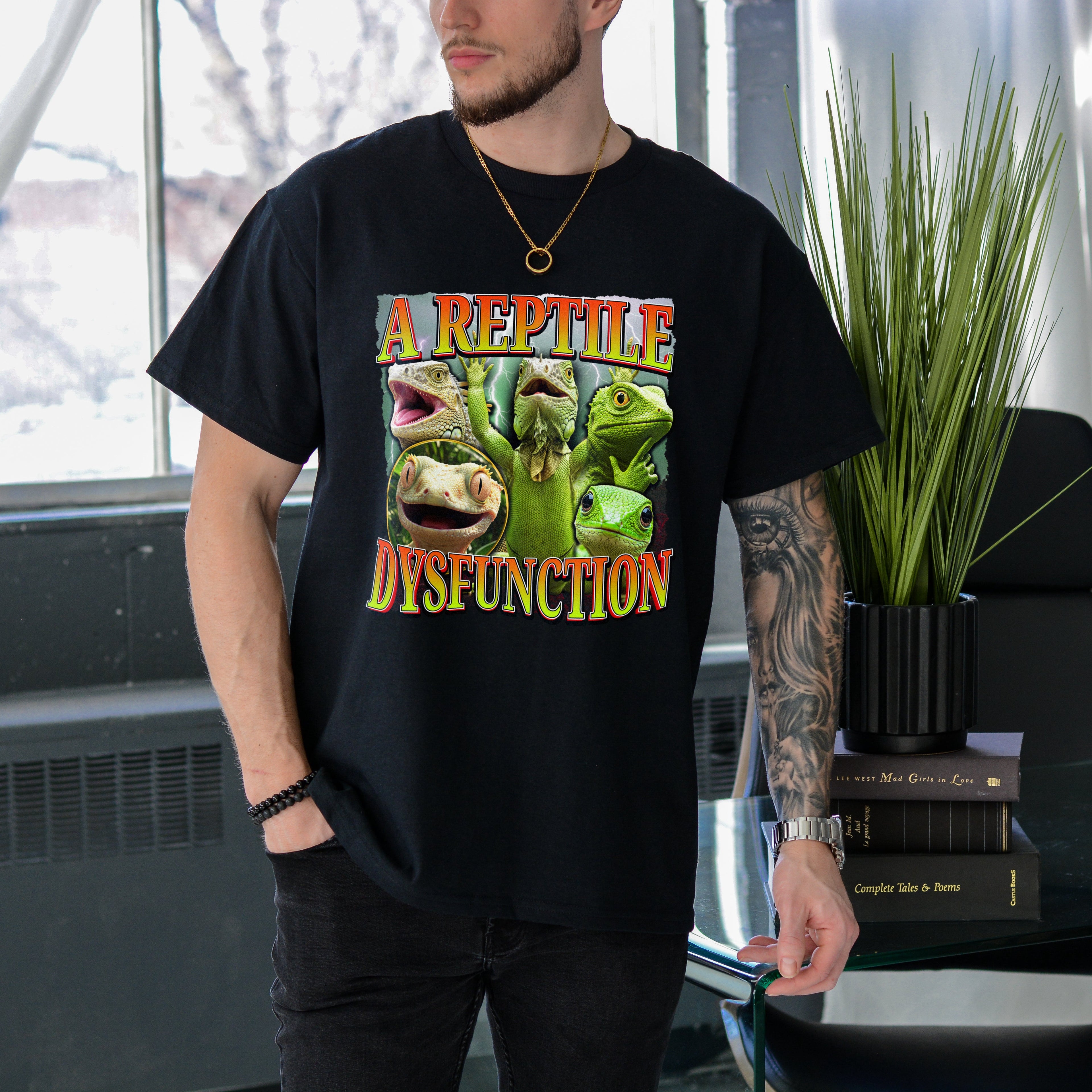 Person wearing a black t-shirt with a graphic design and text in an indoor setting.