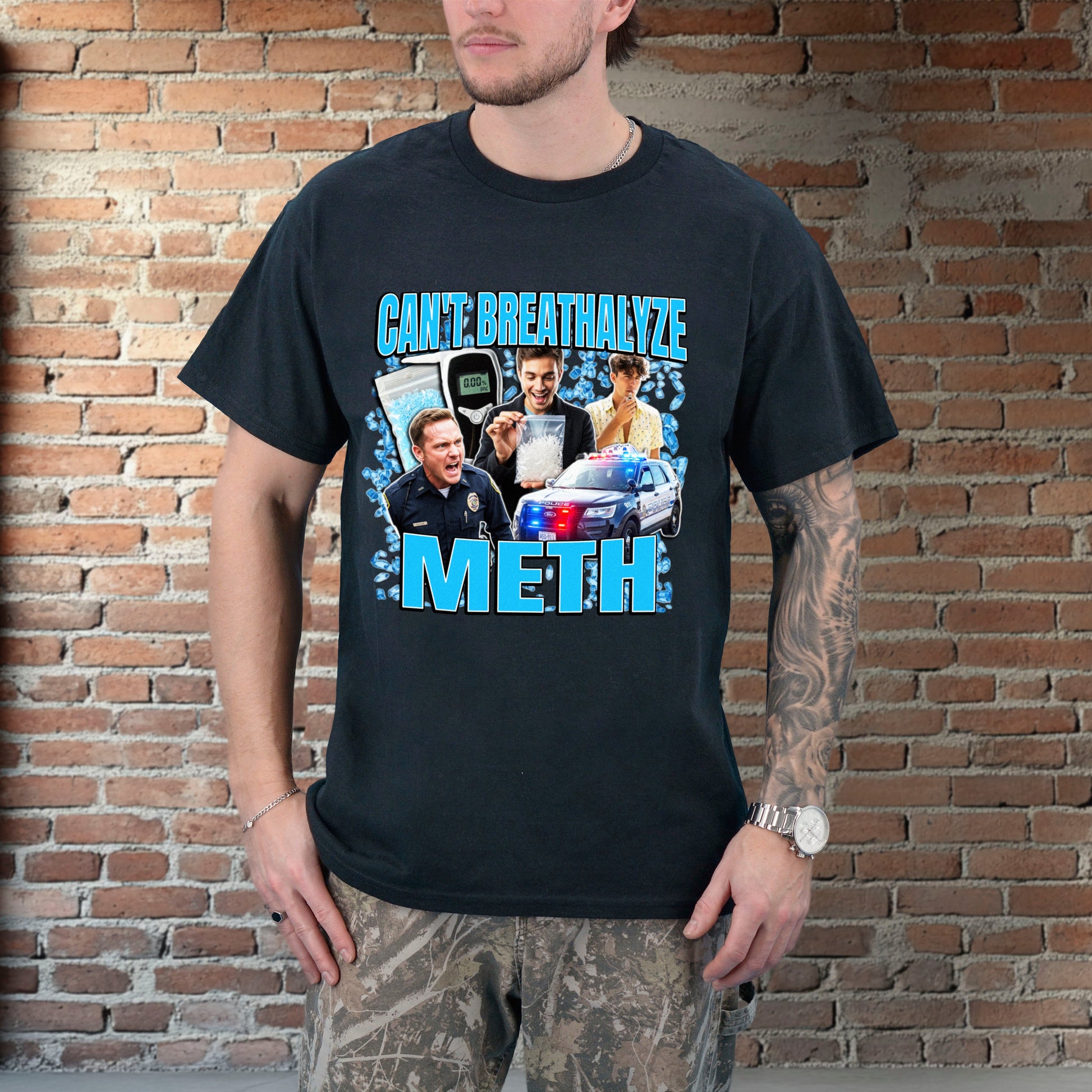 Person wearing a black t-shirt with graphic design and text against a brick wall.