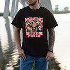 Person wearing a black t-shirt with graphic design and text by a body of water.