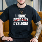Person wearing a black t-shirt with text sitting on a mustard yellow couch.