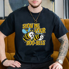 Person wearing a black t-shirt with a graphic design and text, sitting on a mustard yellow couch.