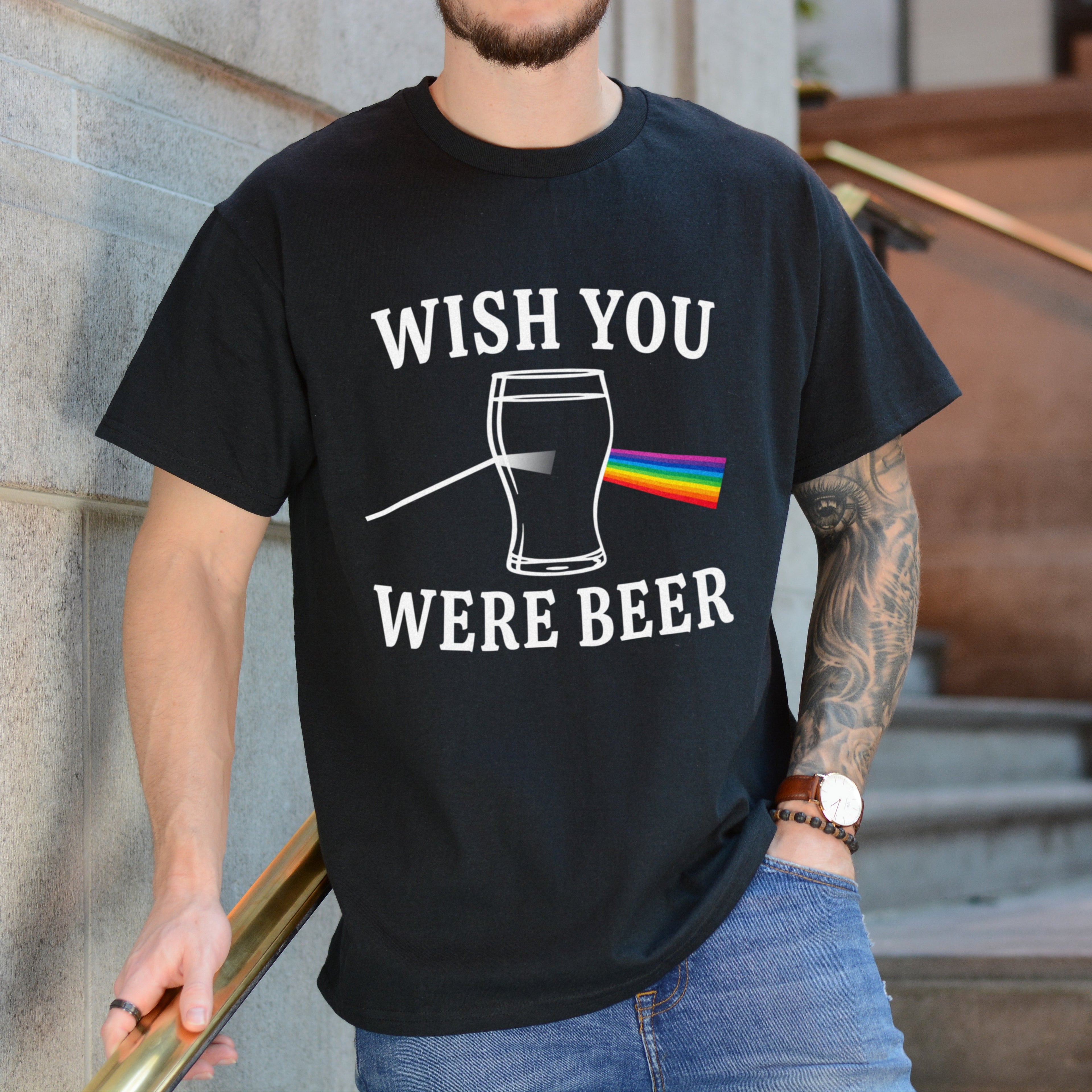 Person wearing a black t-shirt with 'Wish You Were Beer' graphic design.
